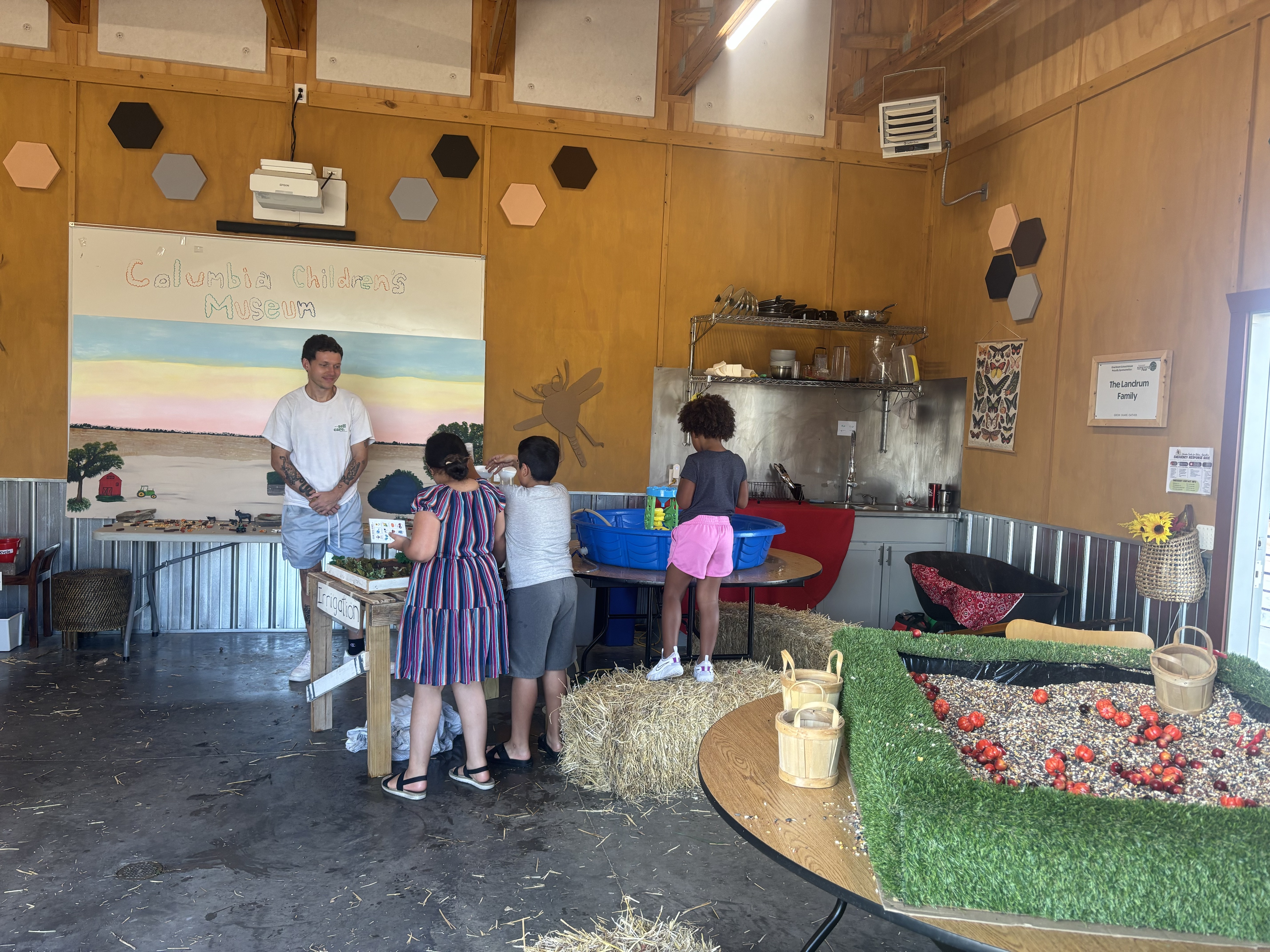 Families exploring a hands-on exhibit at the museum